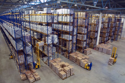 Interior large warehouse with freight stacked high.