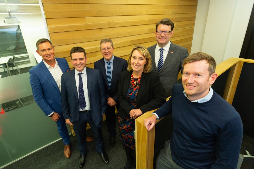 The pic shows Joe Cusdin, front, with, back left to right, Taming the Dragon event organizer Russell Copley, Ed Capes of Fraser Brown, Pat Doody and Samantha Harrison of Greater Lincolnshire LEP, and Lewis Stringer of the British Business Bank.